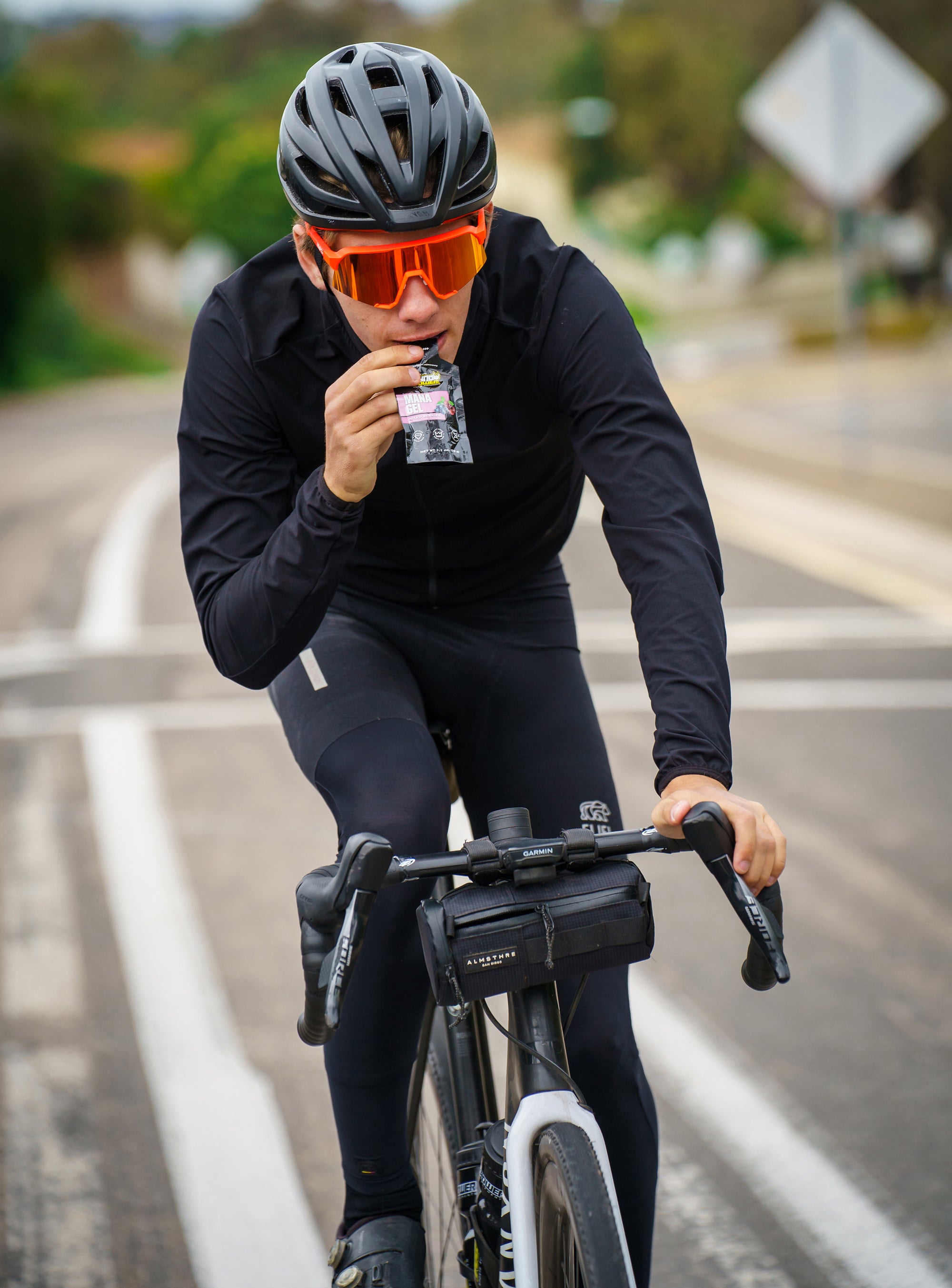 Road Cyclist eating a gel